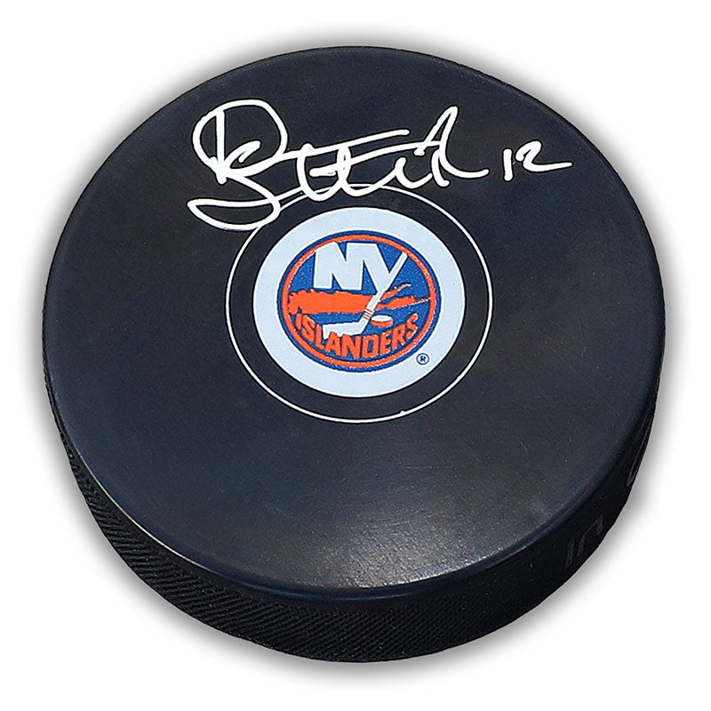 Black NHL hockey puck with New York Islanders logo; puck is signed by Duane Sutter.