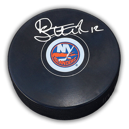 Black NHL hockey puck with New York Islanders logo; puck is signed by Duane Sutter. 