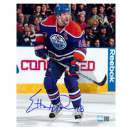 Signed photo of Ethan Moreau Edmonton Oilers skating during an NHL hockey game wearing royal blue jersey with captain's C. Photo is signed at the bottom left in blue.