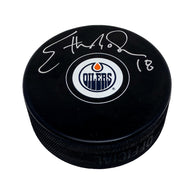 Edmonton Oilers souvenir puck signed by Ethan Moreau in silver ink on the top half of the puck .