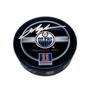 Black hockey puck with Mark Messier retirement night official NHL game puck design. Puck is signed by Mark Messier in silver ink.