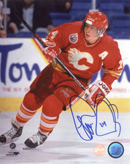 Theo Fleury of the Calgary Flames skating during a Calgary Flames NHL hockey game wearing red jersey with alternate captain's A. photo is signed in blue ink in the bottom right corner