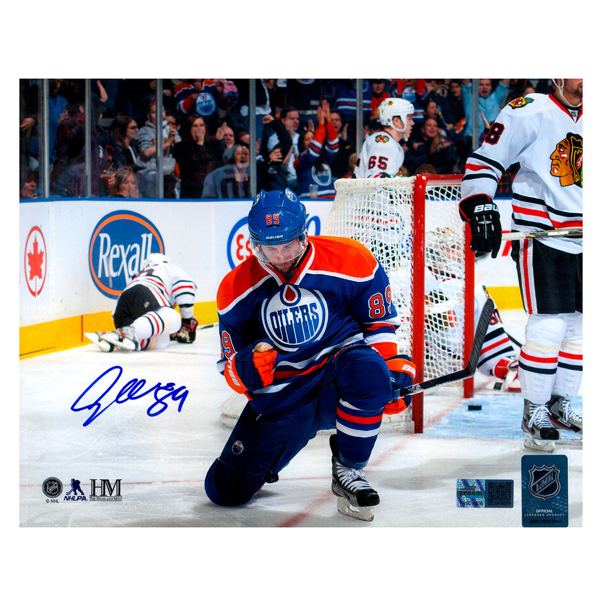 Signed photo of Sam Gagner kneeling in celebration during his 8 point game with the Edmonton Oilers vs the Chicago Blackhawks. Photo is signed in the lower left corner