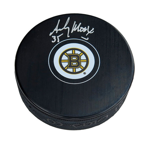 Black hockey puck with Boston Bruins logo in middle of the front, signed by Andy Moog. 