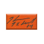 Detail photo of Kevin McClelland's autograph on orange jersey number