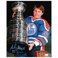 Andy Moog in a hockey jersey holding the Stanley Cup