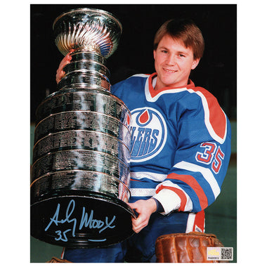 Andy Moog in a hockey jersey holding the Stanley Cup