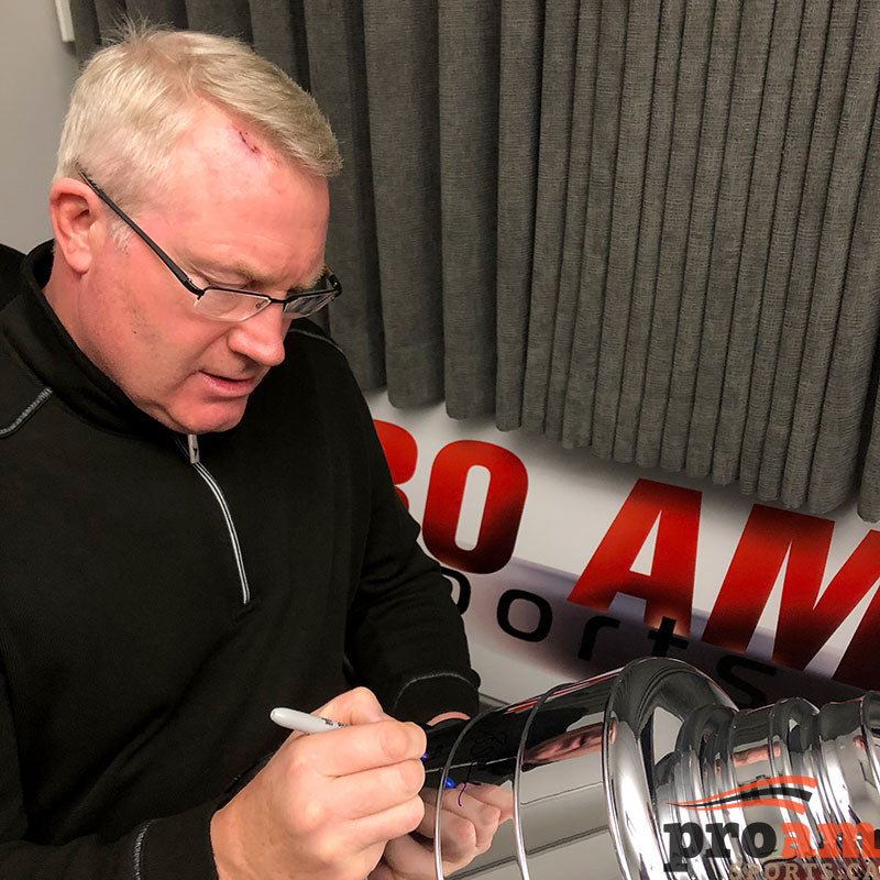Retired Edmonton Oilers player Marty McSorley signing a replica Stanley Cup trophy during a private signing at Pro Am Sports in Edmonton