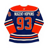 Autographed Edmonton Oilers Hockey jersey with 'Nugent-Hopkins' and number '93' on a white background