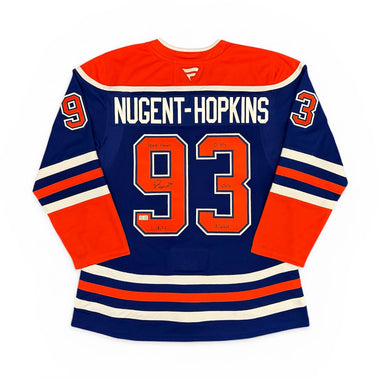 Autographed Edmonton Oilers Hockey jersey with 'Nugent-Hopkins' and number '93' on a white background