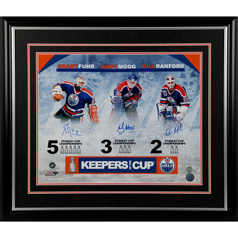 Andy Moog, Grant Fuhr, & Bill Ranford Edmonton Oilers "Keepers of the Cup" Triple autographed 16x20 photograph. Each player is shown in their jersey and pads, their names above and the number of Stanley Cups they've won below. Signatures are done in blue ink. Image is shown framed, with black frame and black mat with orange accent. 