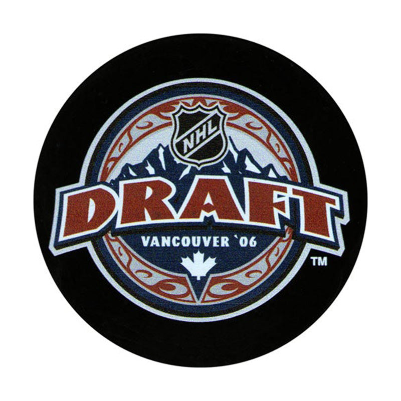 Front view of black hockey puck with the official NHL 2006 Vancouver Draft design