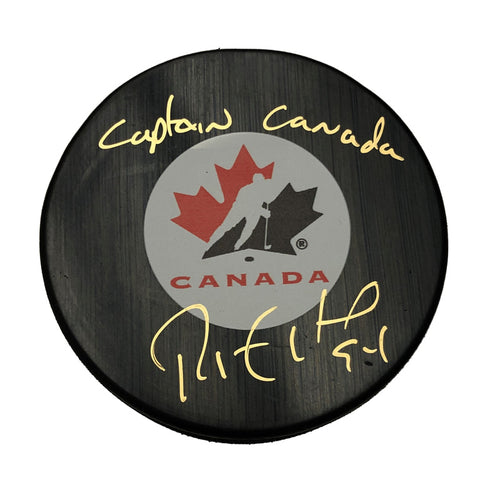 Black hockey puck with Team Canada logo, signed by Ryan Smith in gold ink with inscription "Captain Canada"