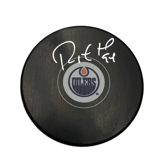 Black NHL hockey puck with Edmonton Oilers logo, signed by Ryan Smyth. 
