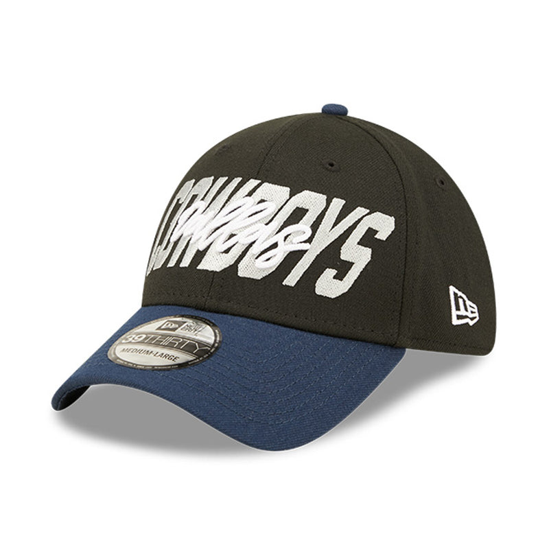 Angled front view of 2022 Dallas Cowboys NFL Draft cap from New Era. Design features embroidered team name on front panels; body of cap is constructed in black with contrasting team colour brim and embroidery.