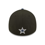 Back view of 2022 Dallas Cowboys NFL Draft cap from New Era. Design features embroidered team name on front panels; body of cap is constructed in black with contrasting team colour brim and embroidery. Full colour team logo is embroidered on the back of the cap. 