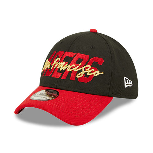 Angled front view of 2022 San Francisco 49ers NFL Draft cap from New Era. Design features embroidered team name on front panels; body of cap is constructed in black with contrasting team colour brim and embroidery.