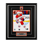 Photo of Edmonton Oilers Josh Archibald skating during an Oilers NHL hockey game, he is wearing white jersey. Photo is signed in blue ink in the lower right. Photo is shown framed, with black framing and mat with orange accents and inset team pin and description plate. 