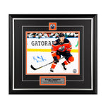 Kailer Yamamoto Edmonton Oilers skating during an NHL hockey game wearing orange jersey. Photo is signed in the lower left corner. Photo is shown framed, with black frame and mat with orange accents, including inset team pin and engraved description plate. 