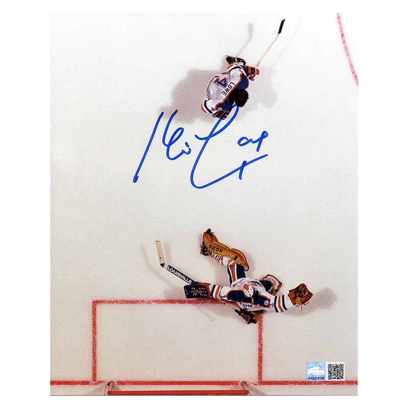 Overhead shot of Kevin Lowe and Grant Fuhr during an Edmonton Oilers NHL hockey game. Image is signed by Kevin Lowe in blue ink. 