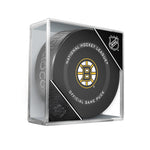 Black hockey puck with NHL official game puck design and Boston Bruins logo in the centre. Displayed in a clear acrylic puck case with NHL shield in the corner. 