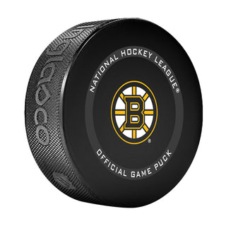Angled front view of black hockey puck with NHL official game puck text and Boston Bruins logo in the centre. 