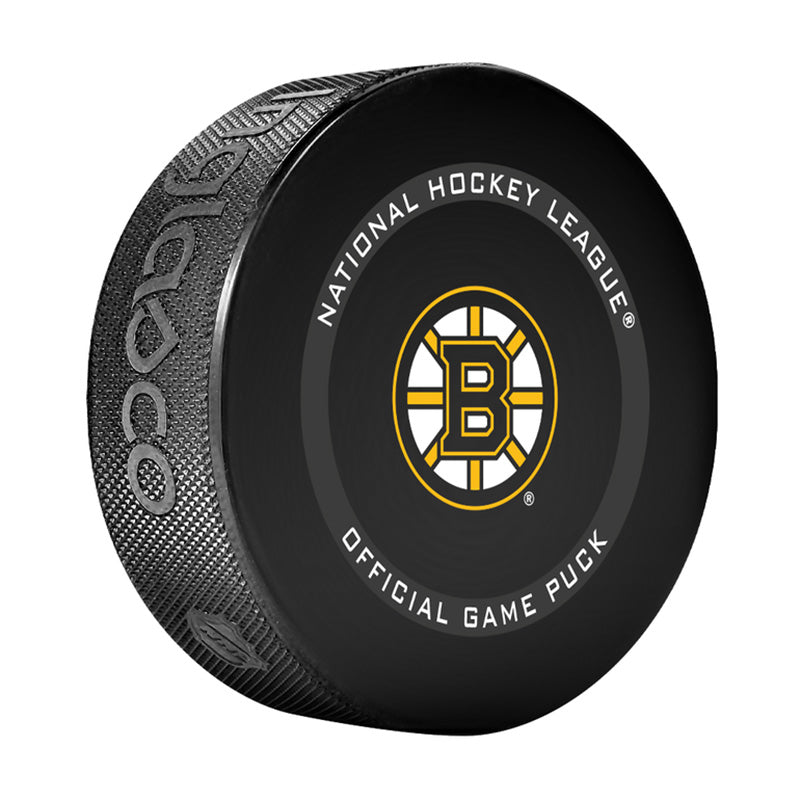 Angled front view of black hockey puck with NHL official game puck text and Boston Bruins logo in the centre. 