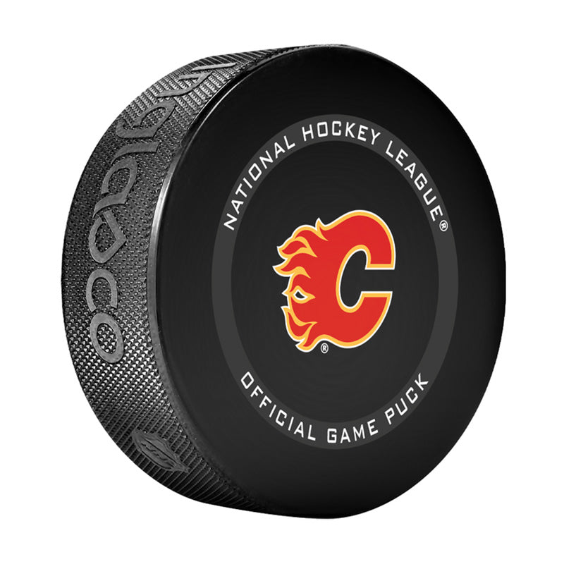 Angled front view of black hockey puck with NHL official game puck branding and Calgary Flames logo in the centre. 