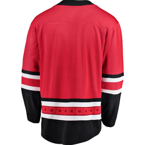 Back view of replica red Carolina Hurricanes NHL home jersey with black and white stripes on sleeves and bottom hem. 