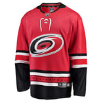 Front view of replica red Carolina Hurricanes NHL home jersey with white and black bands on sleeves and hem, and laces on collar
