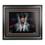 Signed photo of Connor McDavid wearing the orange Edmonton Oilers home jersey with a tunnel effect from the photo editing. Framed in black with orange accents