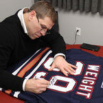 Retired Edmonton Oiler Doug Weight signing a Edmonton Oilers Oil Man NHL jersey during a private signing at Pro Am Sports in Edmonton