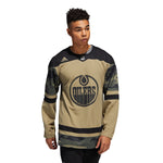 Model wearing Edmonton Oilers camo NHL warmup jersey