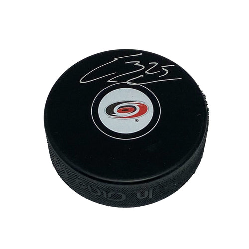 Black hockey puck with Carolina Hurricanes logo signed by Ethan Bear in silver ink.