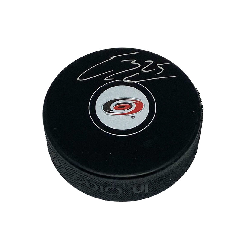 Black hockey puck with Carolina Hurricanes logo signed by Ethan Bear in silver ink.