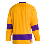 Front view of adidas Vintage team classics 1967 Los Angeles Kings jersey. Design features purple bands on sleeves and lower hem, and purple collar. Primary jersey collar is a bright sunshine yellow. There is a embroidered adidas logo on the lower right hem of the jersey. 