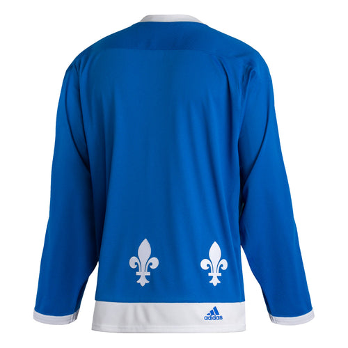 Back view of the adidas vintage team classics 1979 Quebec Nordiques jersey. fleur de lis along the bottom hem. JErsy body is blue with white hems and collar. there is a small embroidered adidas logo on the right side of the bottom hem. 
