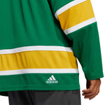 Detail back view of the Front view of the adidas vintage team classics 1970 California Golden Seals jersey, showing the sleeve and bottom hem, including the embroidered adidas loto.