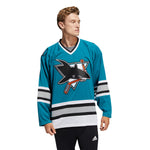 Model wearing the adidas vintage team classics San Jose Sharks 1991 jersey. Model is lookin to the left; he has short blonde wavy hair. 