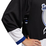 Detail view of the  1992 Tampa Bay Lightning jersey featuring black, white and blue colour blocking. Detail shot showing the underarm venting with small stripes of white and blue. 