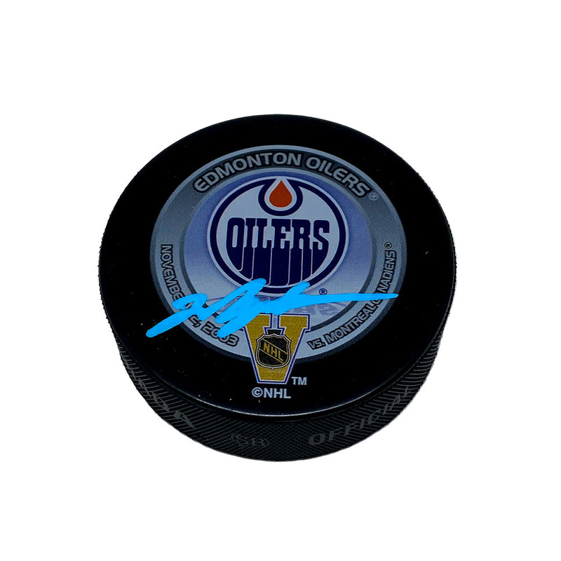 Black hockey puck with official 2003 Heritage Classic Edmonton Oilers vs Montreal Canadiens Game design. Puck is signed by Mark Messier in blue ink. 