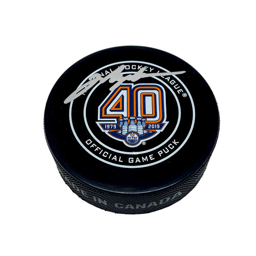 Black hockey puck with NHL Edmonton Oilers 40th Anniversary official game puck design. Puck is signed in silver by Mark Messier. 