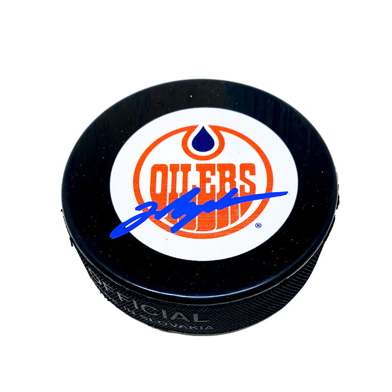 Black hockey puck with Edmonton Oilers vintage 78-79 logo. Puck is signed by Mark Messier in blue ink. 