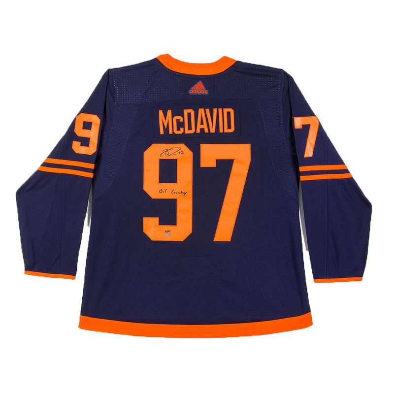 Back view of Connor McDavid autographed and inscribed navy Alternate Edmonton Oilers jersey. Inscription reads "Oil Country"