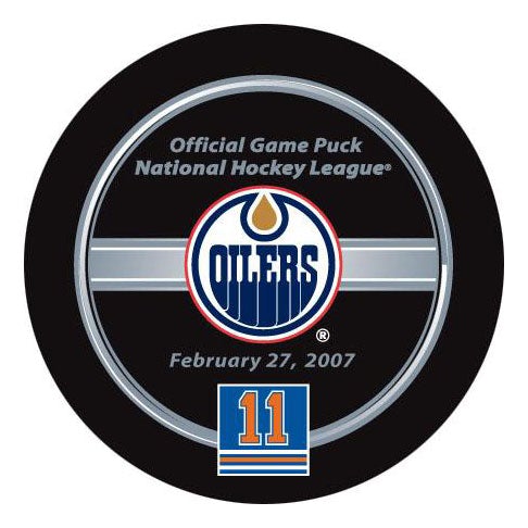 Black hockey puck with official NHL game puck branding featuring Edmonton Oilers commemorative date puck for Mark Messier retirement night on February 27, 2007