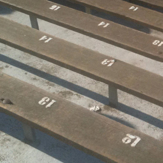Photograph of several rows of  wooden bleacher seats at Notre Dame Stadium. 