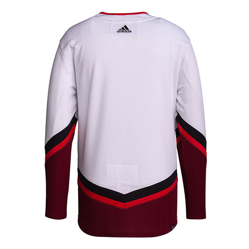Back view of red and white 2022 All-Star game jersey, featuring two red stars on each sleeve, and black and red angled striping on sleeves and bottom hem. 