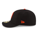 Side view facing left of black San Francisco Giants baseball cap with orange embroidered SF logo on front panels and small New Era logo on left side of low profile 59Fifty fitted baseball cap. 