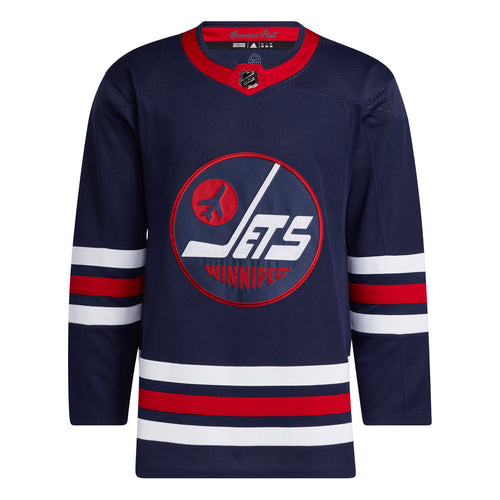 Front view of dark navy Winnipeg Jets NHL home game jersey featuring  red collar, red and white stripes on sleeves and bottom hem, and large front logo