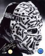 Portrait photo of Gerry Cheevers of the Boston Bruins wearing his famous goalie masks with drawn on "stitches". The photo is in black and white; signed by Cheevers with silver ink in the bottom left corner.  
